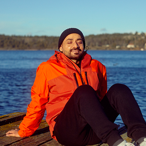 Man sitting by water